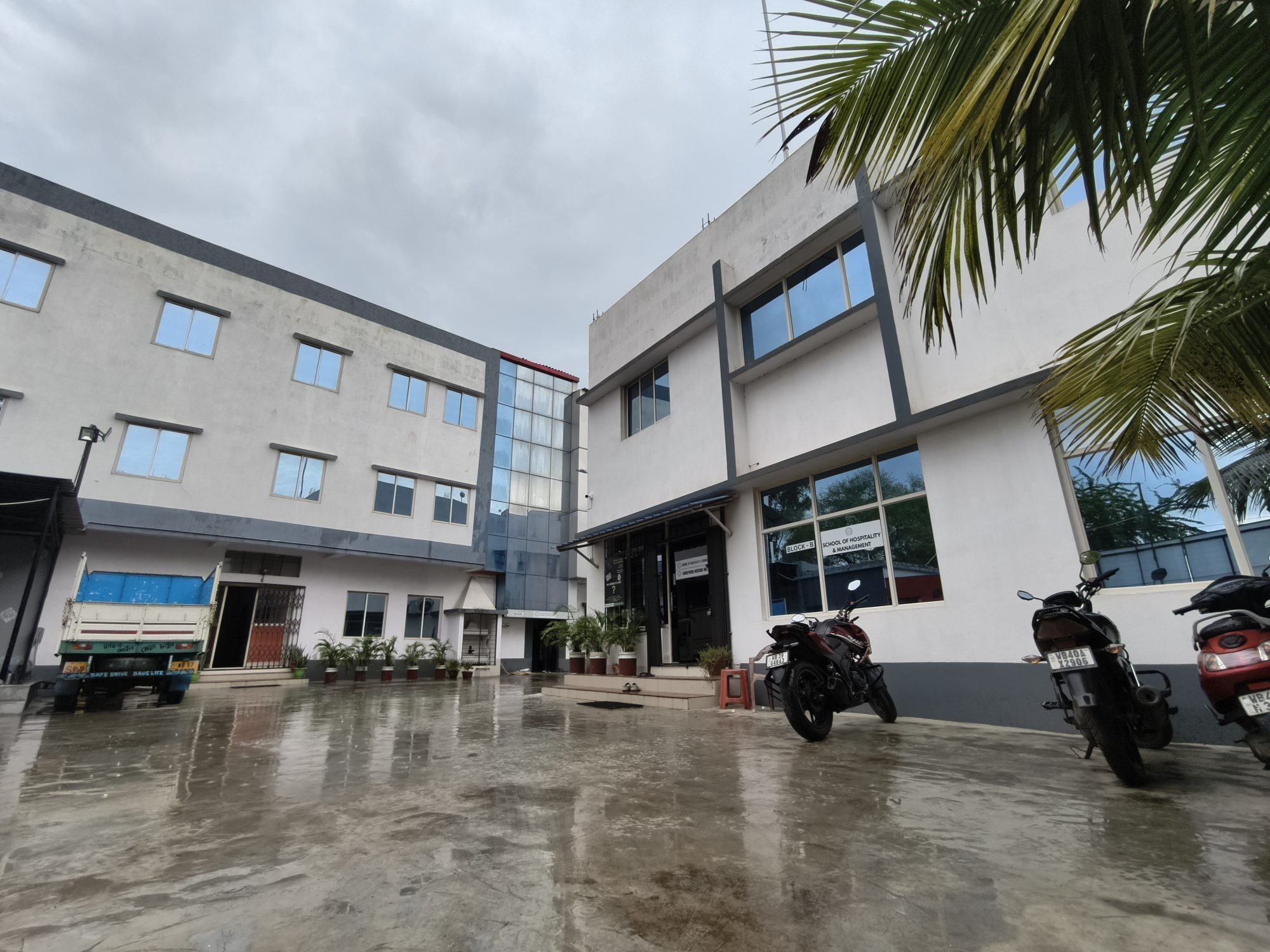The two academic blocks and the paved forecourt at School of Hospitality & Management, Rajbandh, Durgapur