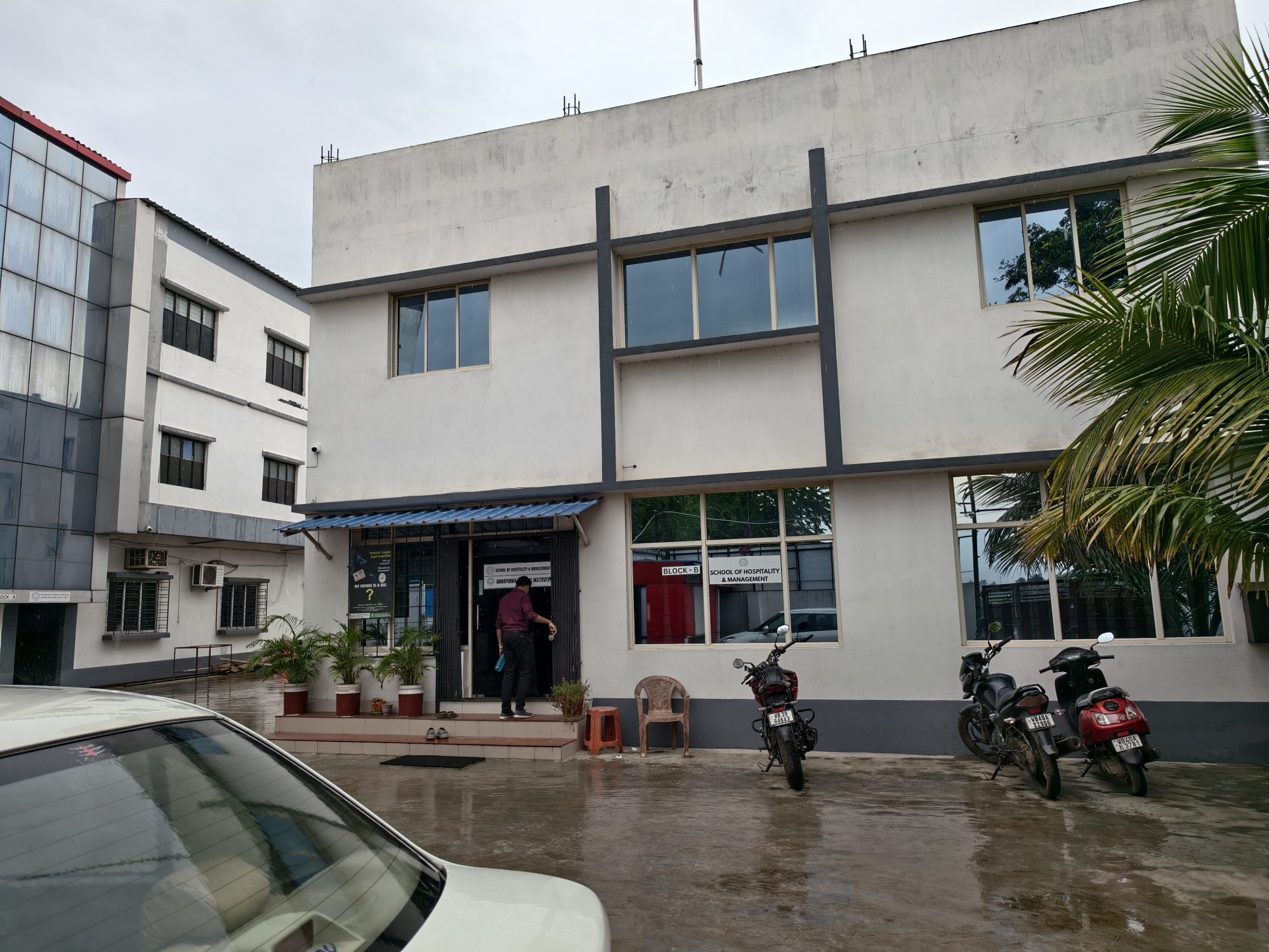 The Block B entrance at School of Hospitality & Management, Durgapur, with the department signboard beside the door