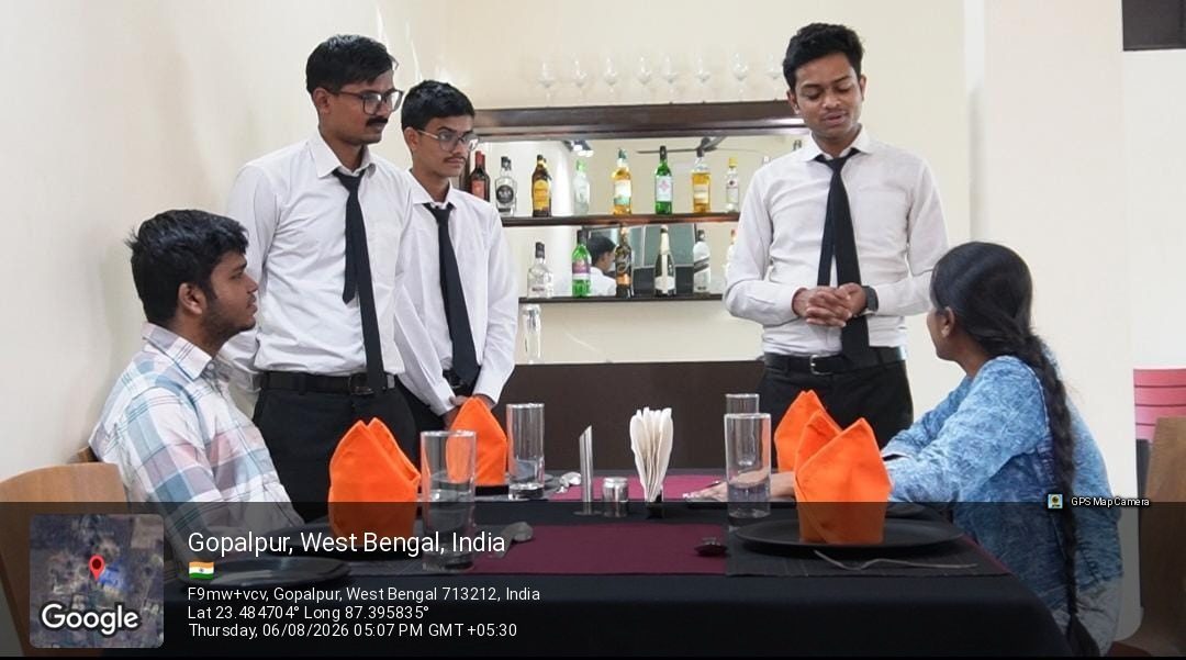 A service briefing at a laid table in the training restaurant at School of Hospitality & Management, Durgapur