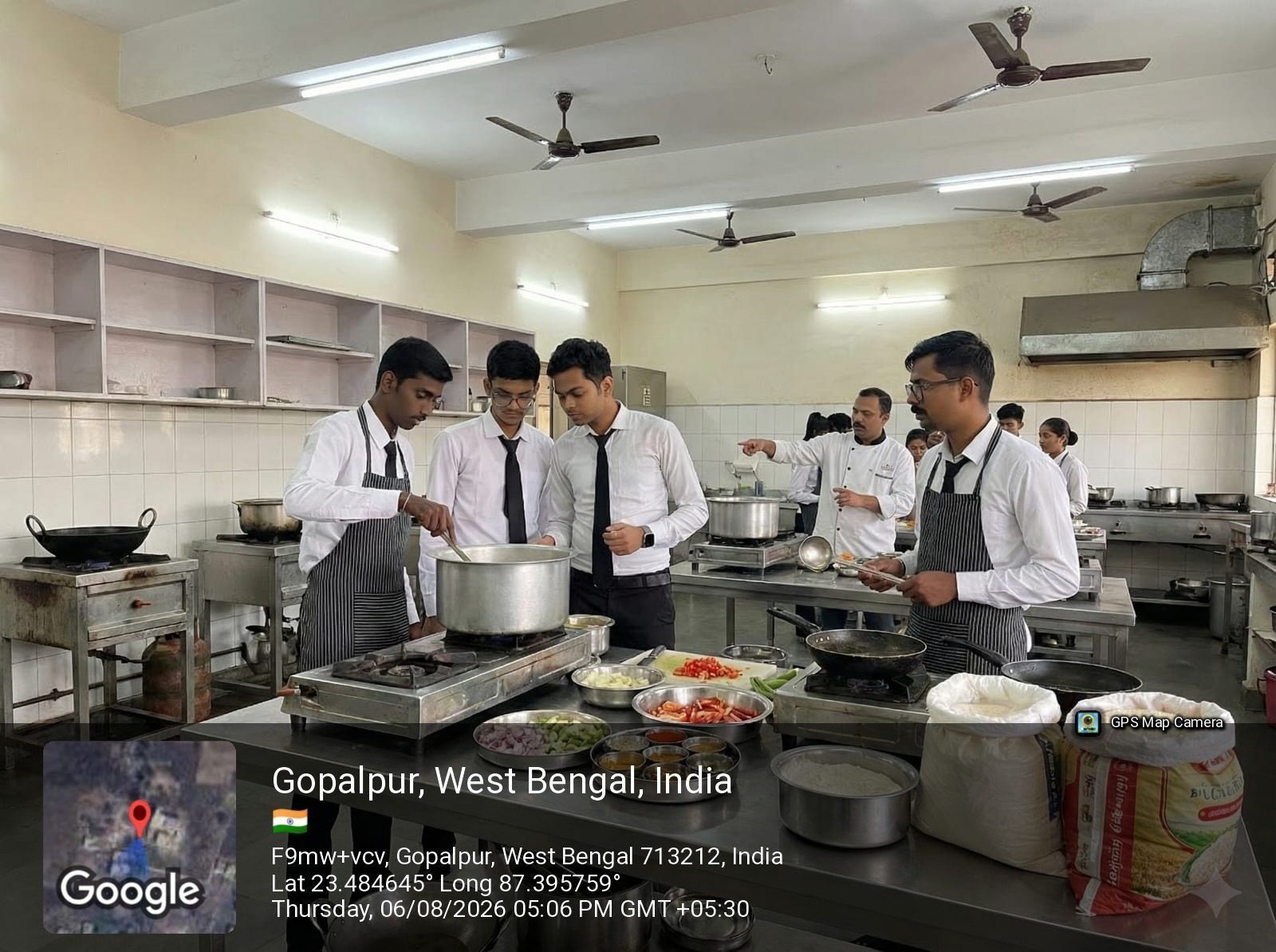 Hotel management students cooking under a chef instructor in the food production lab at School of Hospitality & Management, Durgapur
