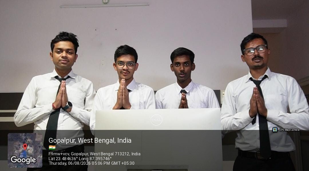 Students in service uniform greeting a guest at the front office training desk at School of Hospitality & Management, Durgapur