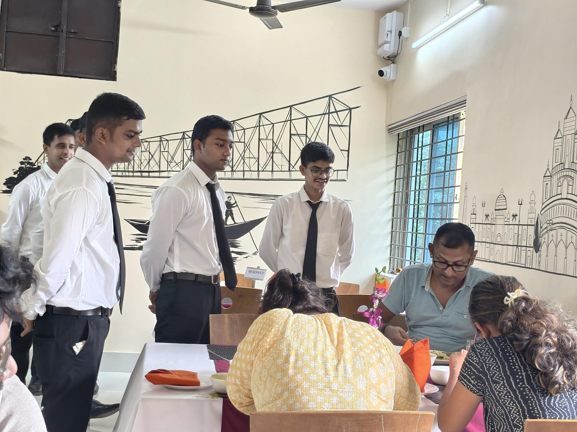 The student service brigade attending tables in the training restaurant at School of Hospitality & Management, Durgapur