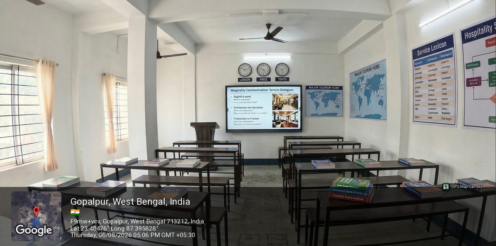 A smart classroom at School of Hospitality & Management, Durgapur, with a display screen, service-lexicon charts and world clocks for London, Paris and Tokyo