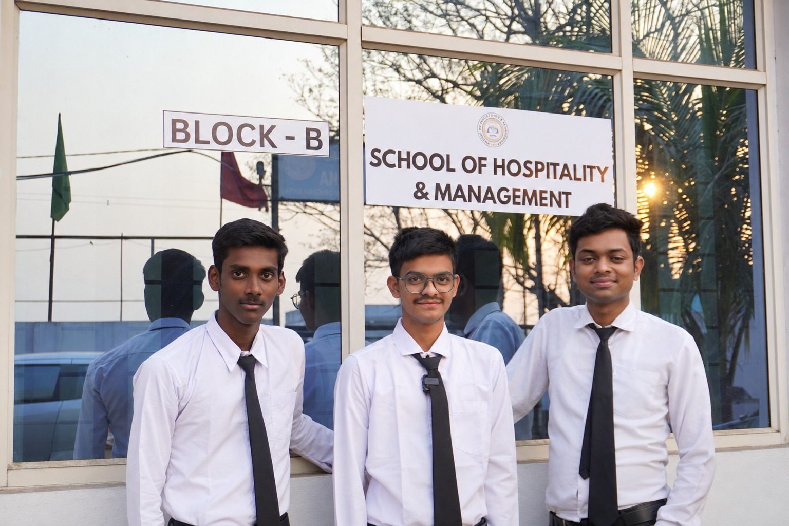 Hotel management students in service uniform outside the Block B entrance at School of Hospitality & Management, Durgapur