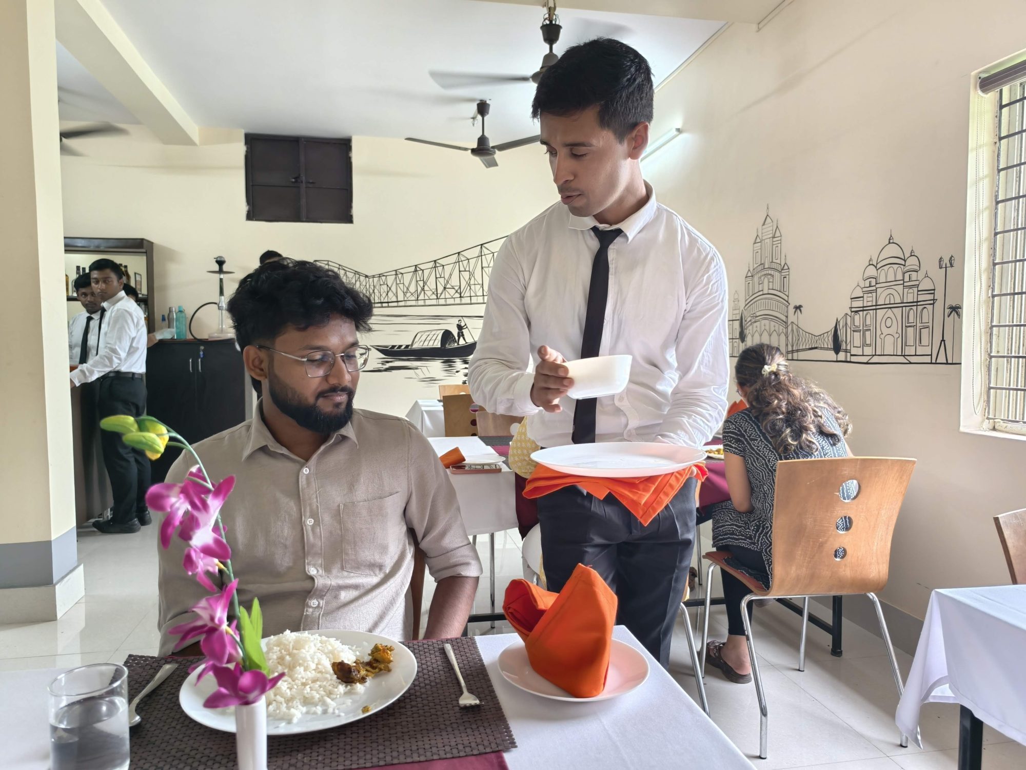 A student placing a bowl beside a guest cover during food and beverage service training at SHM Durgapur