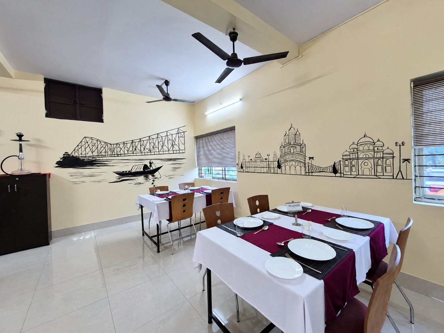 Tables laid with covers, napkins and glassware in the training restaurant at School of Hospitality & Management, Durgapur